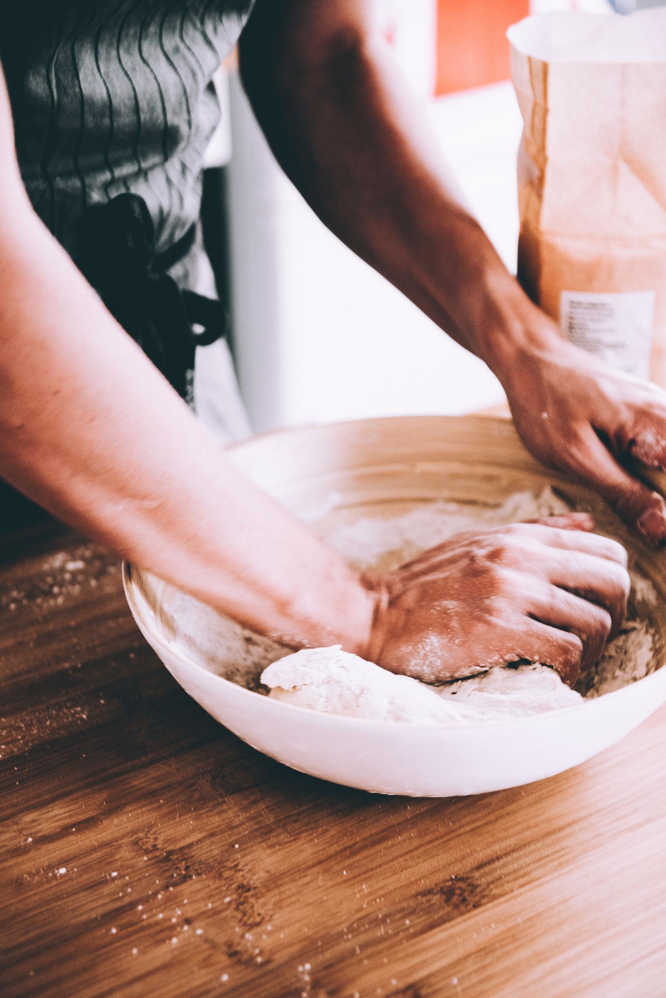 Close-up of hands shaping dough